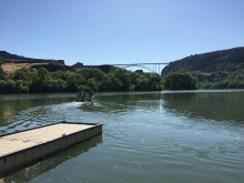 Centennial Waterfront Park boat dock in the Snake River with a jet boat and Perrine Bridge in background wide shot June 2015