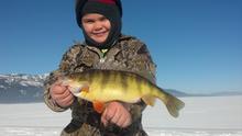 girl with her perch from ice fishing 