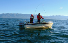 family fishing in a boat for kokanee on Lake Pend Oreille fish on September 2015 medium shot