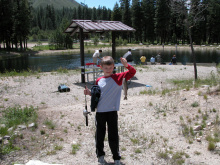 a boy showing off his catch at the Lowman fish pond June 2006