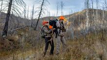 Mother and Daughter strapping elk antlers onto a backpack for a pack-out