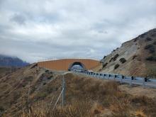 Vehicles travel under the newly completed wildlife overpass structure on Highway 21 near Boise