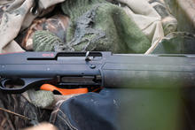 waterfowl hunting shotgun in boat