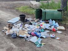 Tipped over garbage can with garbage strewn about