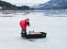 Pink girl, black sled - ice fishing in Panhandle of Idaho