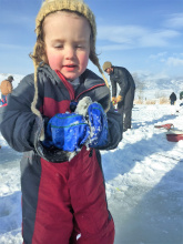 Young child ice fishing at Hyde Pond near Salmon