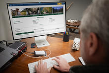 IDFG white male typing on computer tag sale 