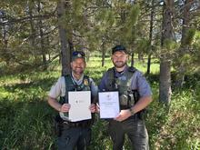 Officers Smith and Johnson holding their American Red Cross Life Saving Awards