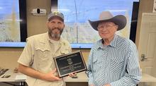 Sammie Hendricks being presented the 2023 Hunter Education Instructor of the Year award by Gerren Steel