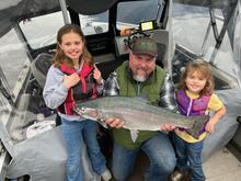 Anglers on Lake Pend Oreille with a rainbow trout
