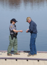 Idaho Fish and Game conservation officer Meghan Roos checks a fishing license near Castleford  March 2010