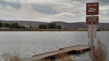 Sawyers Pond Fishing Access pond informational sign and boat dock wide shot October 2016