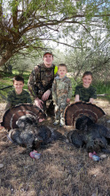 dad and kids with their two turkey during the youth turkey hunt 2015