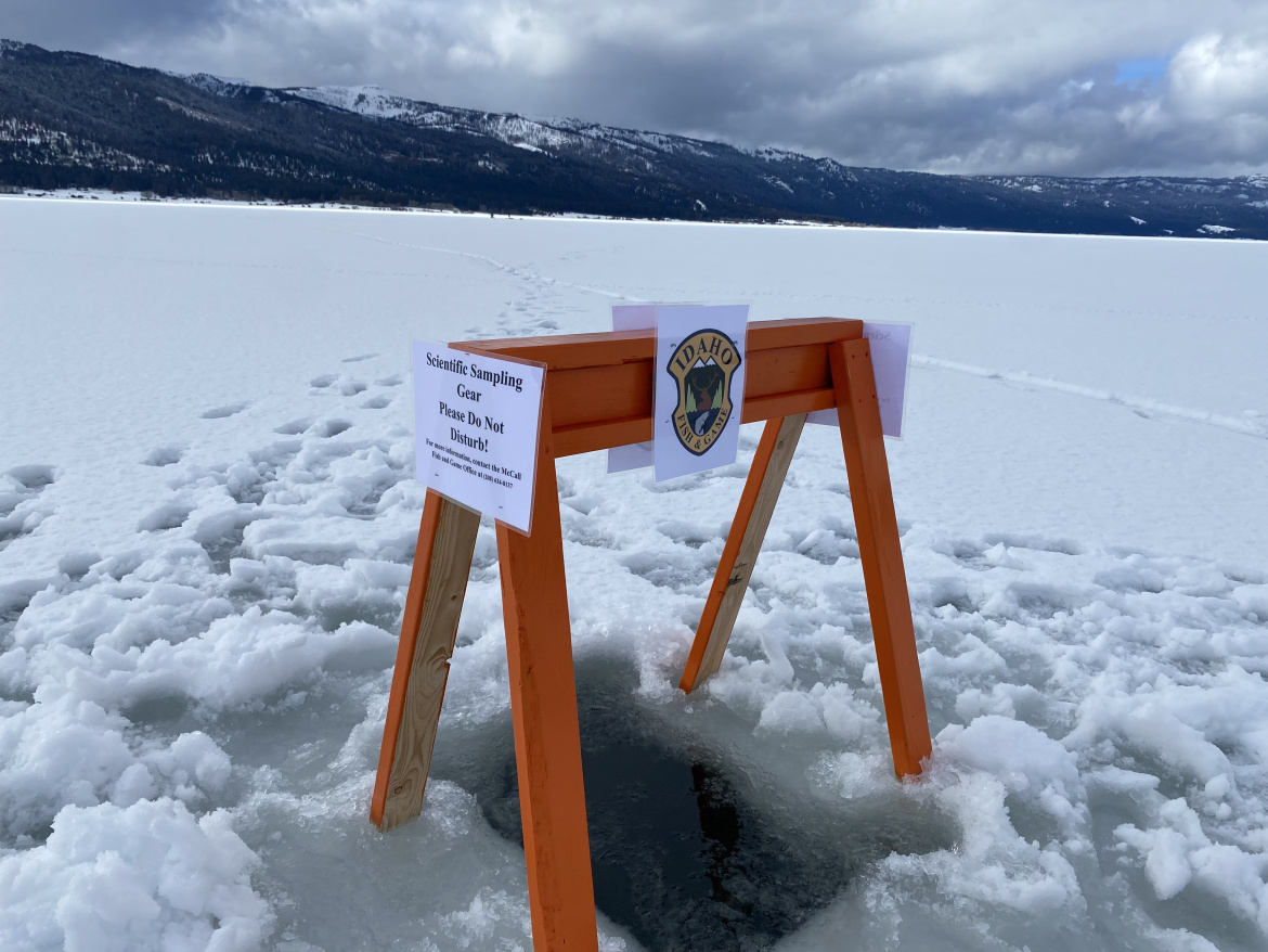 A sign notifying anglers of a hole in the ice and associated scientific sampling taking place on Lake Cascade in January 2023. 