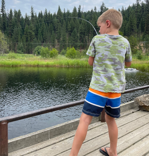 Child fishing for stocked rainbow trout