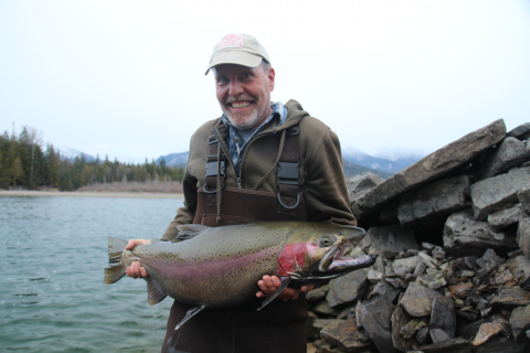 Angler with large rainbow trout caught in Lake Pend Oreille