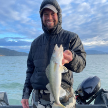 Stock photo of an angler with a walleye from Lake Pend Oreille