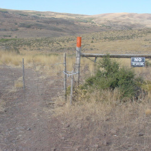 medium shot of a posted no trespassing sign and orange painted fence post September 2005