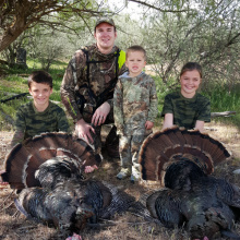 dad and kids with their two turkey during the youth turkey hunt 2015